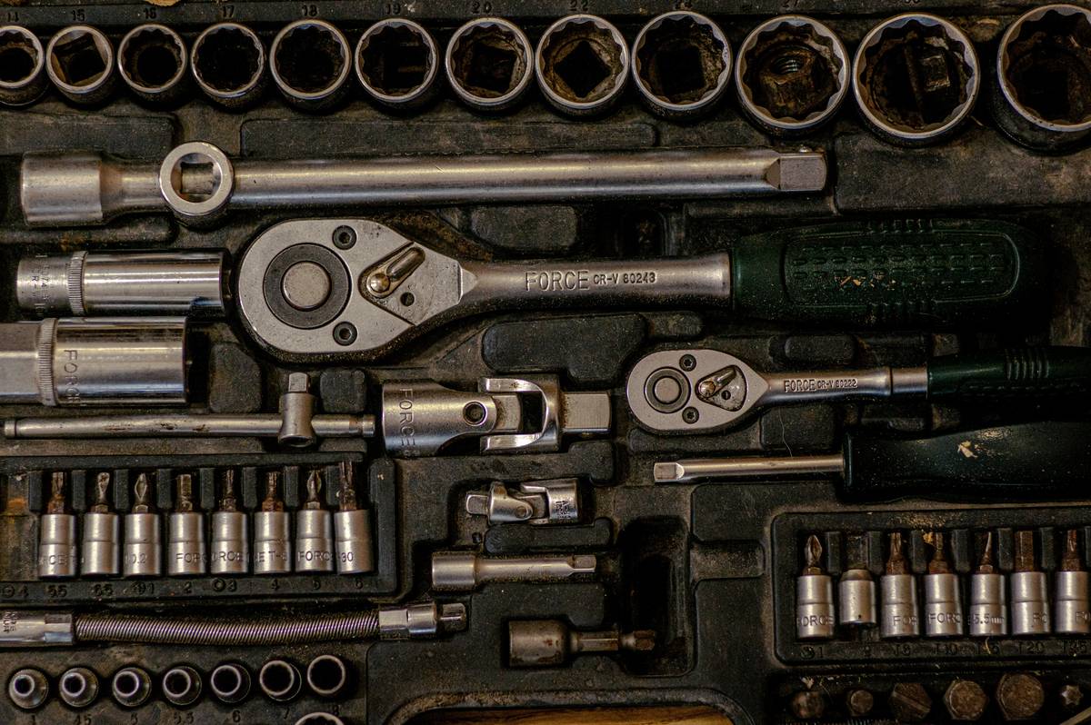 A neatly arranged list of recovery tools including foam rollers, resistance bands, massage balls, and kinesiology tape on a clean mat